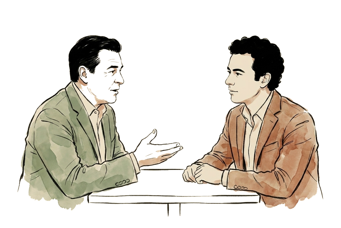 Duas pessoas em conversa a uma mesa